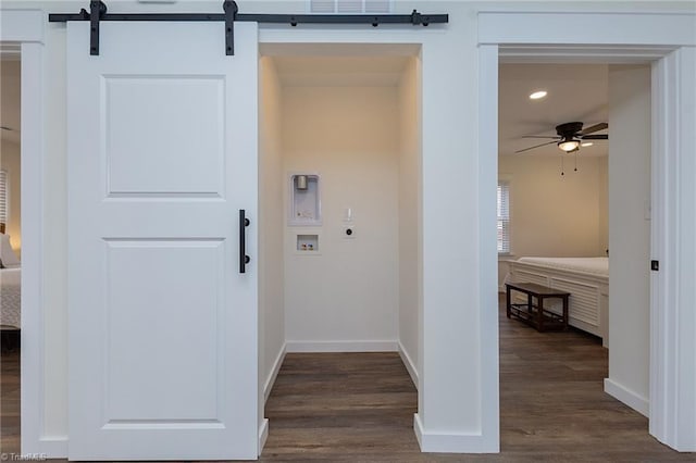 hallway with recessed lighting, baseboards, dark wood-type flooring, and a barn door