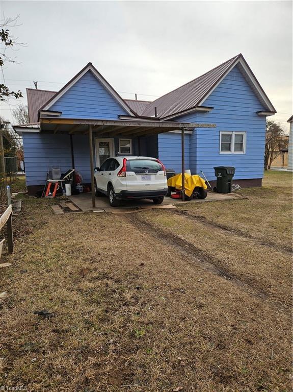 back of house with a lawn