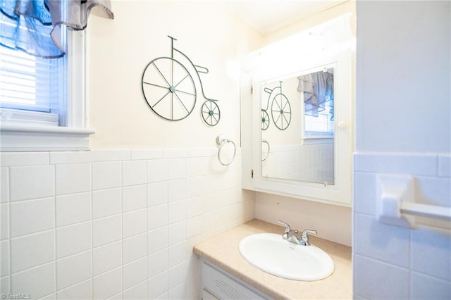 bathroom with wainscoting, tile walls, and vanity