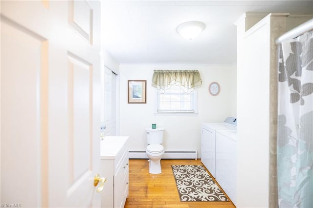 full bath featuring a baseboard heating unit, vanity, washer and clothes dryer, and wood finished floors