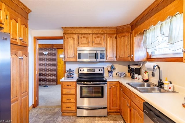 kitchen with a sink, stainless steel appliances, and light countertops