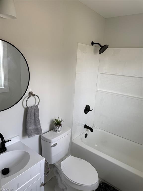 full bathroom featuring toilet, shower / bathing tub combination, and vanity