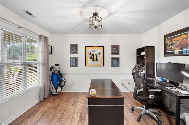 home office featuring visible vents, wood finished floors, and baseboards