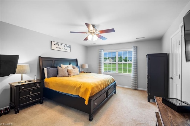 bedroom featuring baseboards, visible vents, ceiling fan, and light colored carpet
