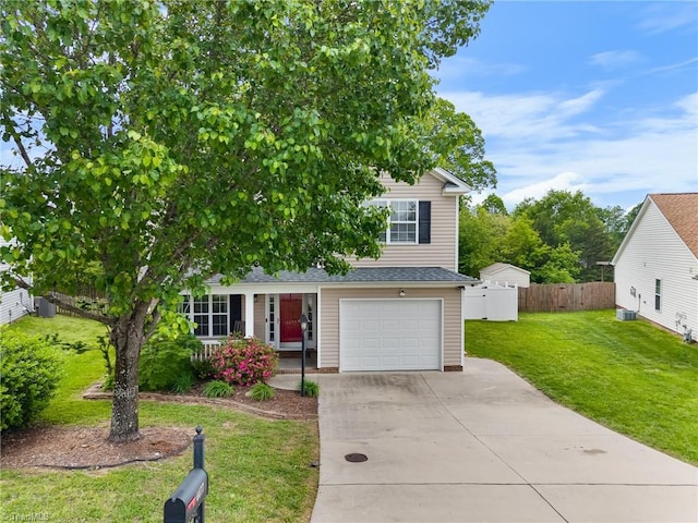 view of front of house with a porch, fence, driveway, a front yard, and an attached garage