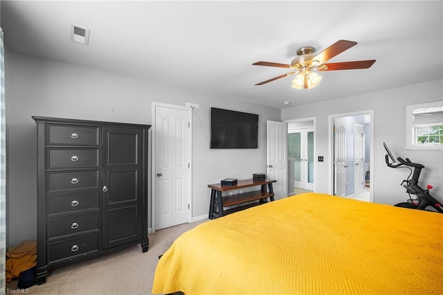 bedroom featuring connected bathroom, visible vents, baseboards, light carpet, and a ceiling fan
