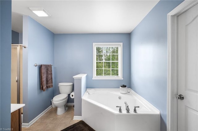 full bath with vanity, a bath, toilet, baseboards, and tile patterned flooring