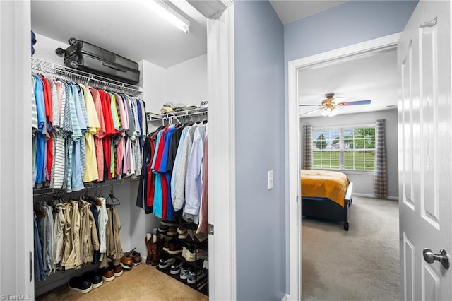 spacious closet with carpet flooring and ceiling fan