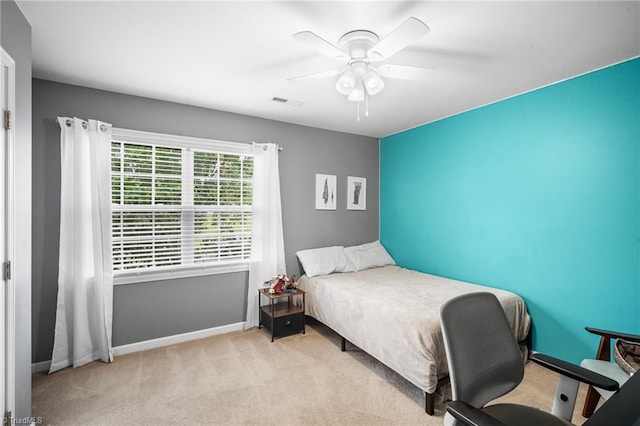 carpeted bedroom featuring visible vents, a ceiling fan, and baseboards