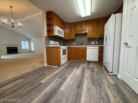 kitchen featuring tasteful backsplash, open shelves, wood finished floors, a chandelier, and white appliances
