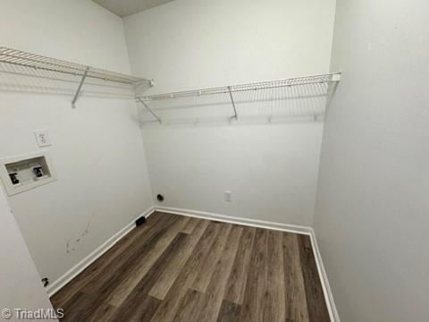 laundry room with washer hookup, baseboards, laundry area, and wood finished floors