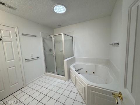 full bath with a textured ceiling, tile patterned floors, a jetted tub, a shower stall, and visible vents