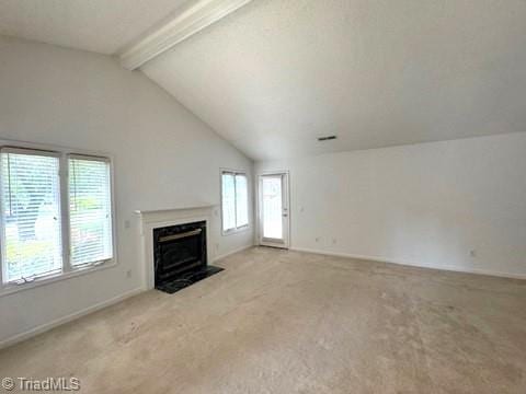 unfurnished living room featuring baseboards, a fireplace with flush hearth, vaulted ceiling with beams, and carpet