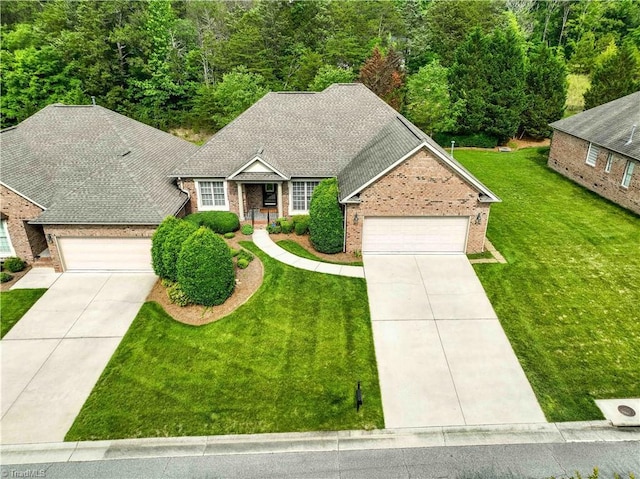 2334 Addison Blvd, High Point, NC 27262 - view of front facade with driveway, an attached garage, and brick siding