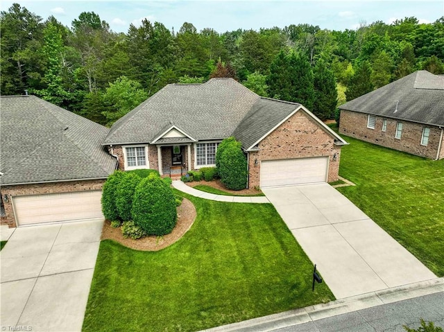 2334 Addison Blvd, High Point, NC 27262 - view of front of home featuring driveway, brick siding, an attached garage, and a front yard