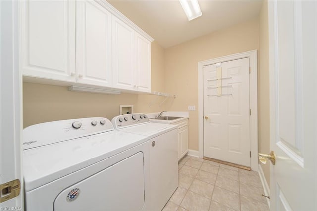 2334 Addison Blvd, High Point, NC 27262 - laundry area featuring washing machine and clothes dryer, cabinet space, baseboards, and light tile patterned flooring