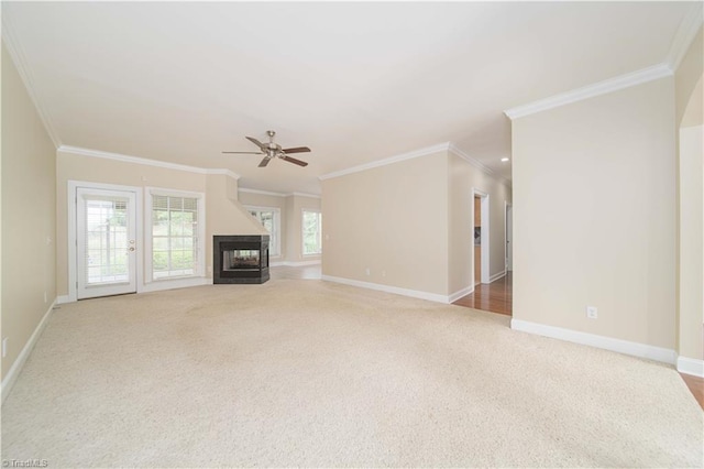 2334 Addison Blvd, High Point, NC 27262 - unfurnished living room featuring carpet, crown molding, a ceiling fan, baseboards, and a multi sided fireplace