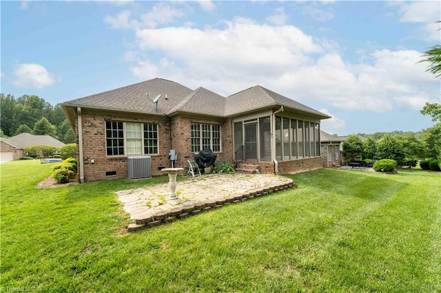 2334 Addison Blvd, High Point, NC 27262 - rear view of property featuring a sunroom, a patio, brick siding, a yard, and central AC unit
