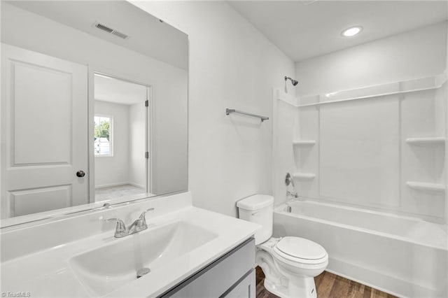 full bathroom with wood-type flooring, vanity, toilet, and shower / bathtub combination