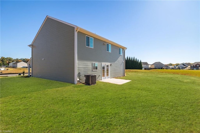 back of house featuring french doors, a yard, and central air condition unit