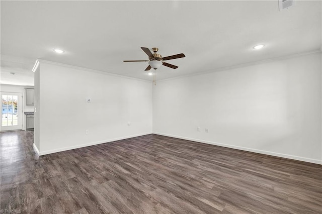 empty room featuring dark hardwood / wood-style flooring, ceiling fan, and ornamental molding