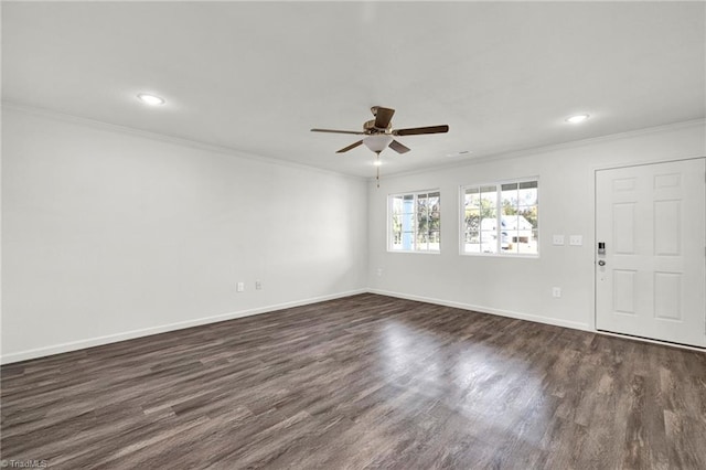 empty room featuring dark hardwood / wood-style floors, ceiling fan, and crown molding