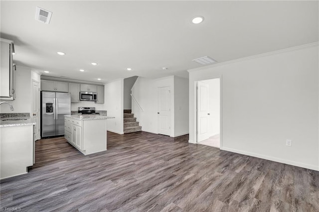 kitchen with stainless steel appliances, crown molding, dark wood-type flooring, sink, and a kitchen island