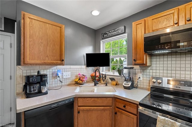 kitchen featuring a sink, appliances with stainless steel finishes, tasteful backsplash, and light countertops