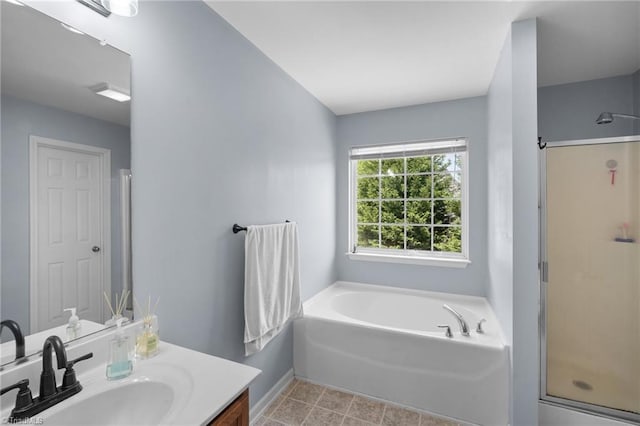 bathroom featuring vanity, baseboards, a shower stall, and a garden tub