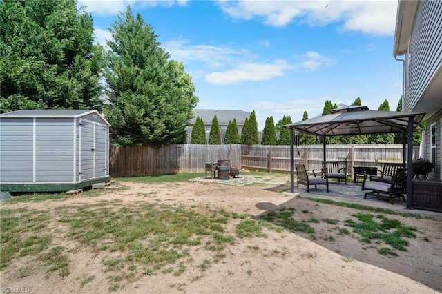 view of yard featuring a storage shed, a patio area, a gazebo, an outdoor structure, and a fenced backyard