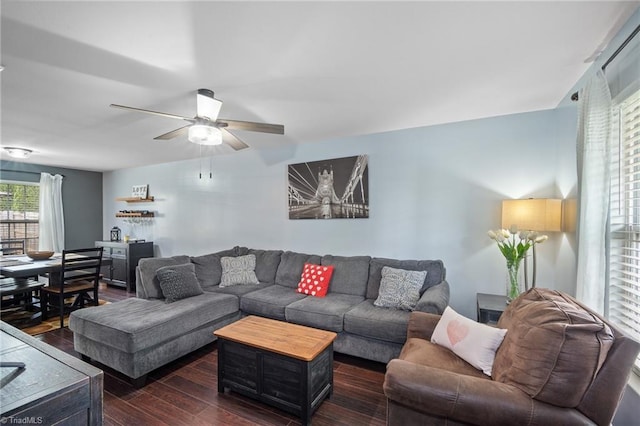 living area with a ceiling fan and dark wood-style flooring