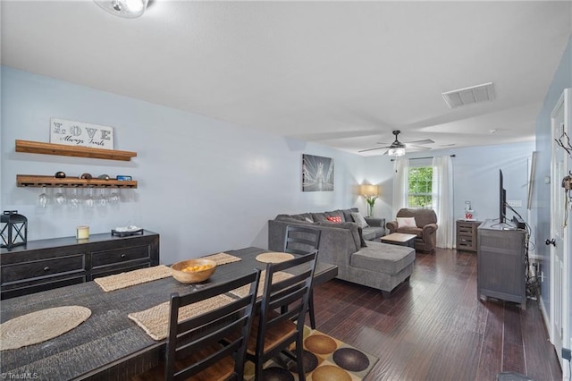 dining space with visible vents, a ceiling fan, and dark wood-style flooring