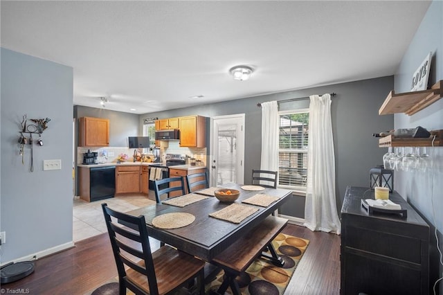 dining room featuring light wood-style floors and baseboards
