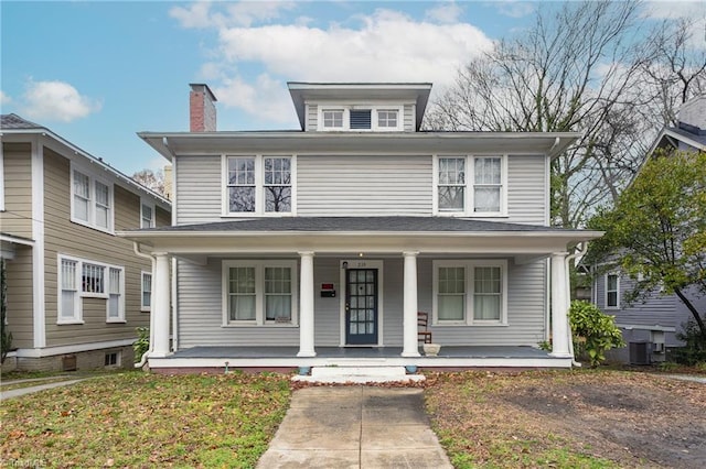 view of property with covered porch and central air condition unit