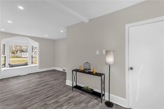 interior space featuring baseboards, wood finished floors, beam ceiling, and recessed lighting