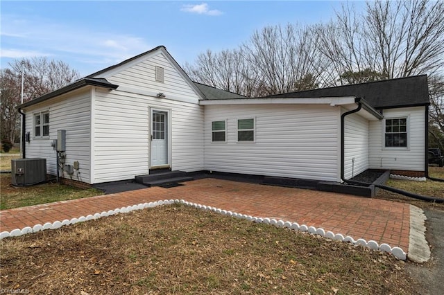 back of property with central air condition unit, a patio area, and entry steps