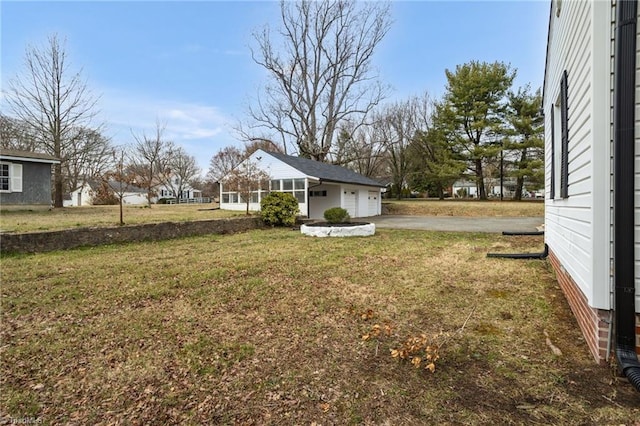 view of yard with driveway and an attached garage