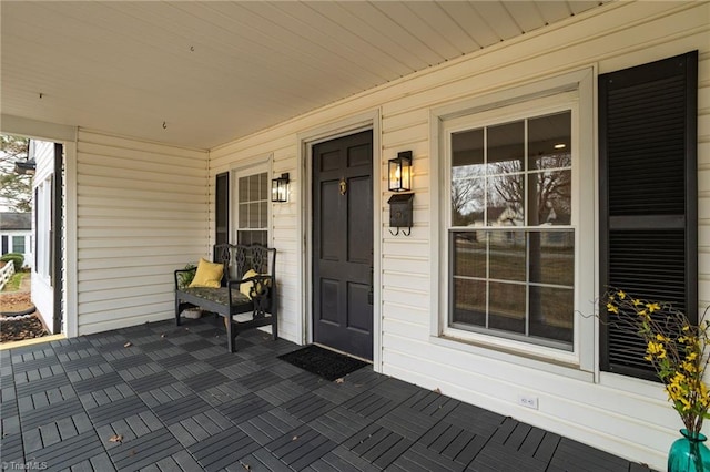 view of exterior entry with a porch