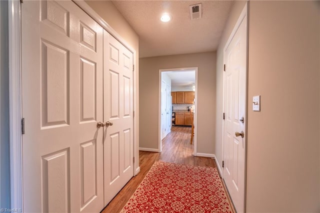 136 Fairway Dr, Bermuda Run, NC 27006 - corridor with light wood-style floors, recessed lighting, and a textured ceiling