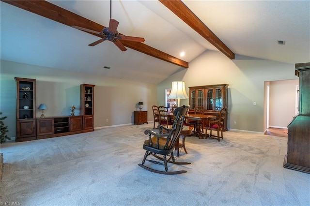 interior space featuring lofted ceiling with beams, ceiling fan, and light carpet