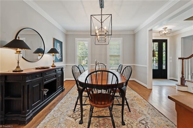 4919 Setter Ct, Jamestown, NC 27282 - dining area with a chandelier, healthy amount of natural light, wood finished floors, and crown molding
