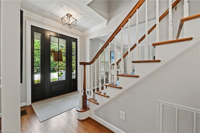 4919 Setter Ct, Jamestown, NC 27282 - entryway with wood finished floors, stairs, ornamental molding, a chandelier, and baseboards