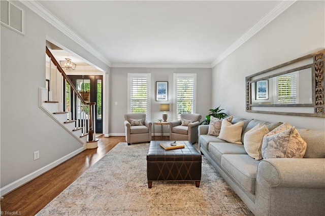 4919 Setter Ct, Jamestown, NC 27282 - living room with ornamental molding, wood finished floors, baseboards, a chandelier, and stairway