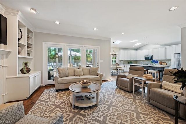 4919 Setter Ct, Jamestown, NC 27282 - living area featuring wood finished floors, ornamental molding, recessed lighting, and a chandelier