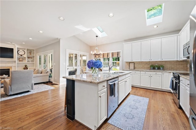 4919 Setter Ct, Jamestown, NC 27282 - kitchen featuring a skylight, stainless steel appliances, white cabinetry, light wood-style flooring, and recessed lighting