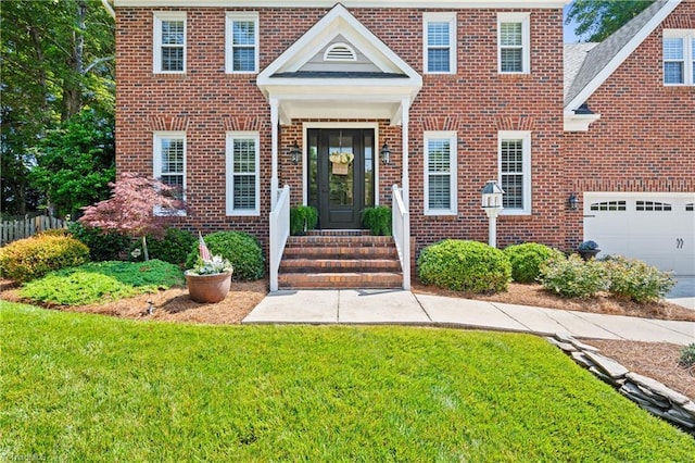 4919 Setter Ct, Jamestown, NC 27282 - colonial inspired home with brick siding, a front yard, and an attached garage