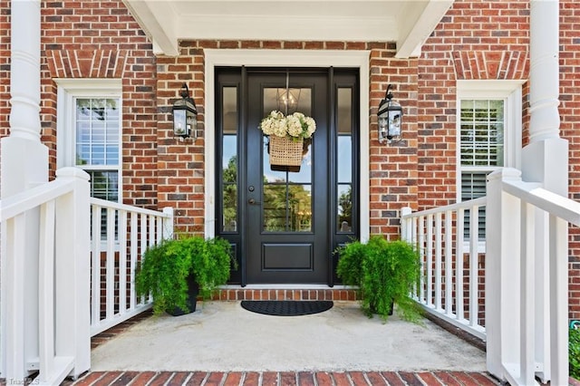 4919 Setter Ct, Jamestown, NC 27282 - view of exterior entry featuring brick siding and a porch