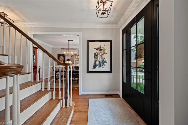 4919 Setter Ct, Jamestown, NC 27282 - foyer with a chandelier, stairway, crown molding, wood finished floors, and baseboards