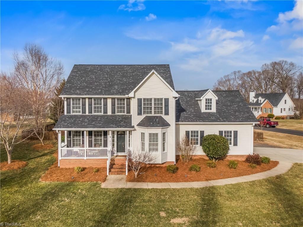 view of front of property with a front yard and covered porch