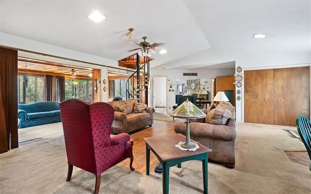 living room featuring light colored carpet, lofted ceiling, and ceiling fan